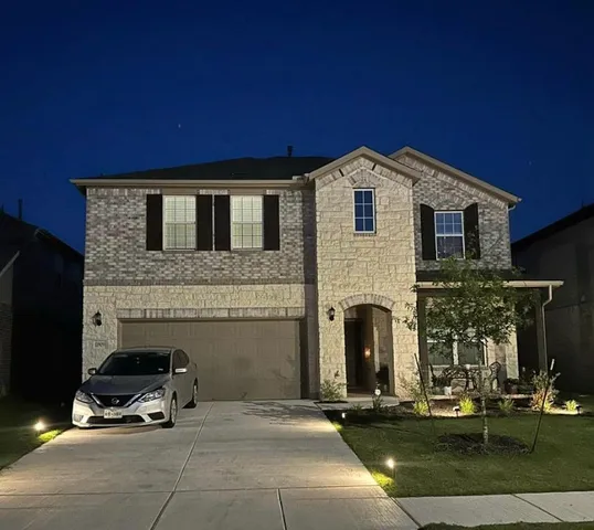 a front view of a house with parking space