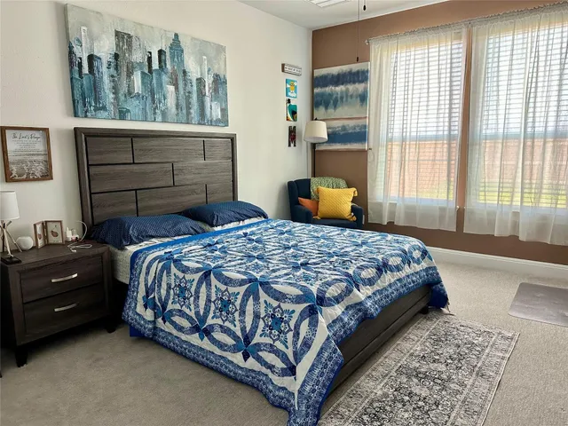 a bedroom with a bed window and walk in closet