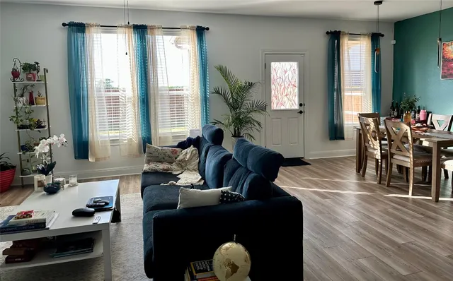 a living room with furniture potted plant a sink and a window