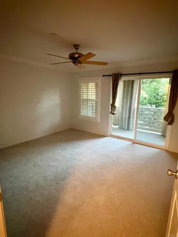 a view of a livingroom with a ceiling fan and window