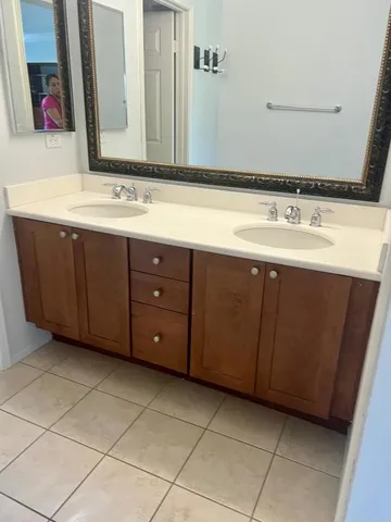 a bathroom with a sink vanity and a mirror