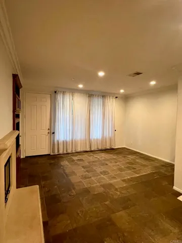 a view of an empty room with windows