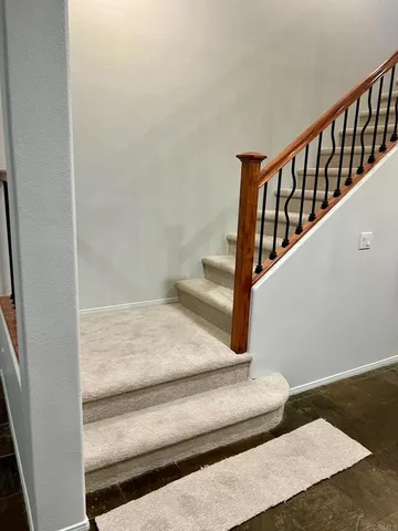 a view of staircase with white walls