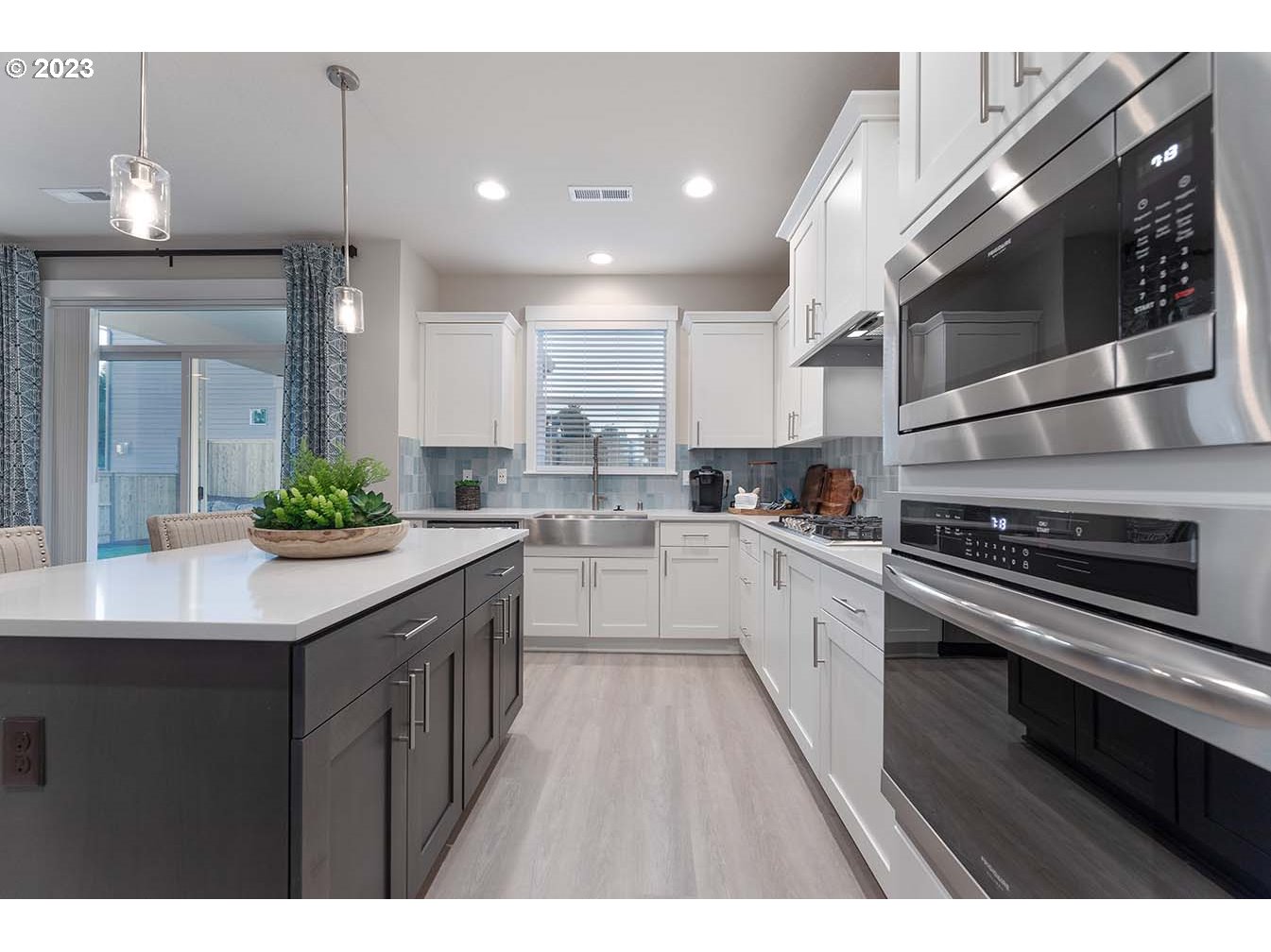 302 North 89th Loop Ridgefield, WA 98642 - Photo 8 of 29 a kitchen with stainless steel appliances kitchen island granite countertop a sink and cabinets