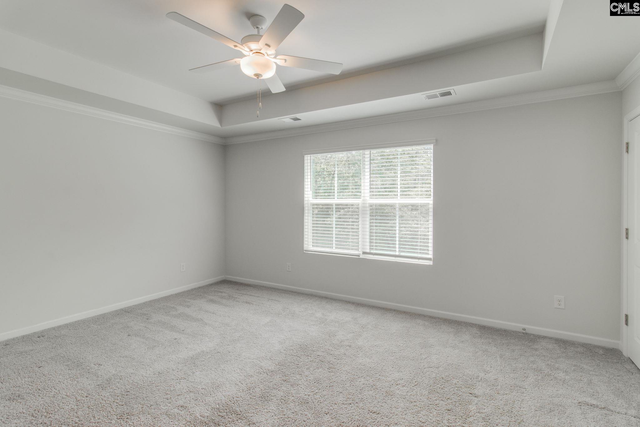 312 Reedmace Court Lexington, SC 29072 - Photo 15 of 29 an empty room with a window and a fan