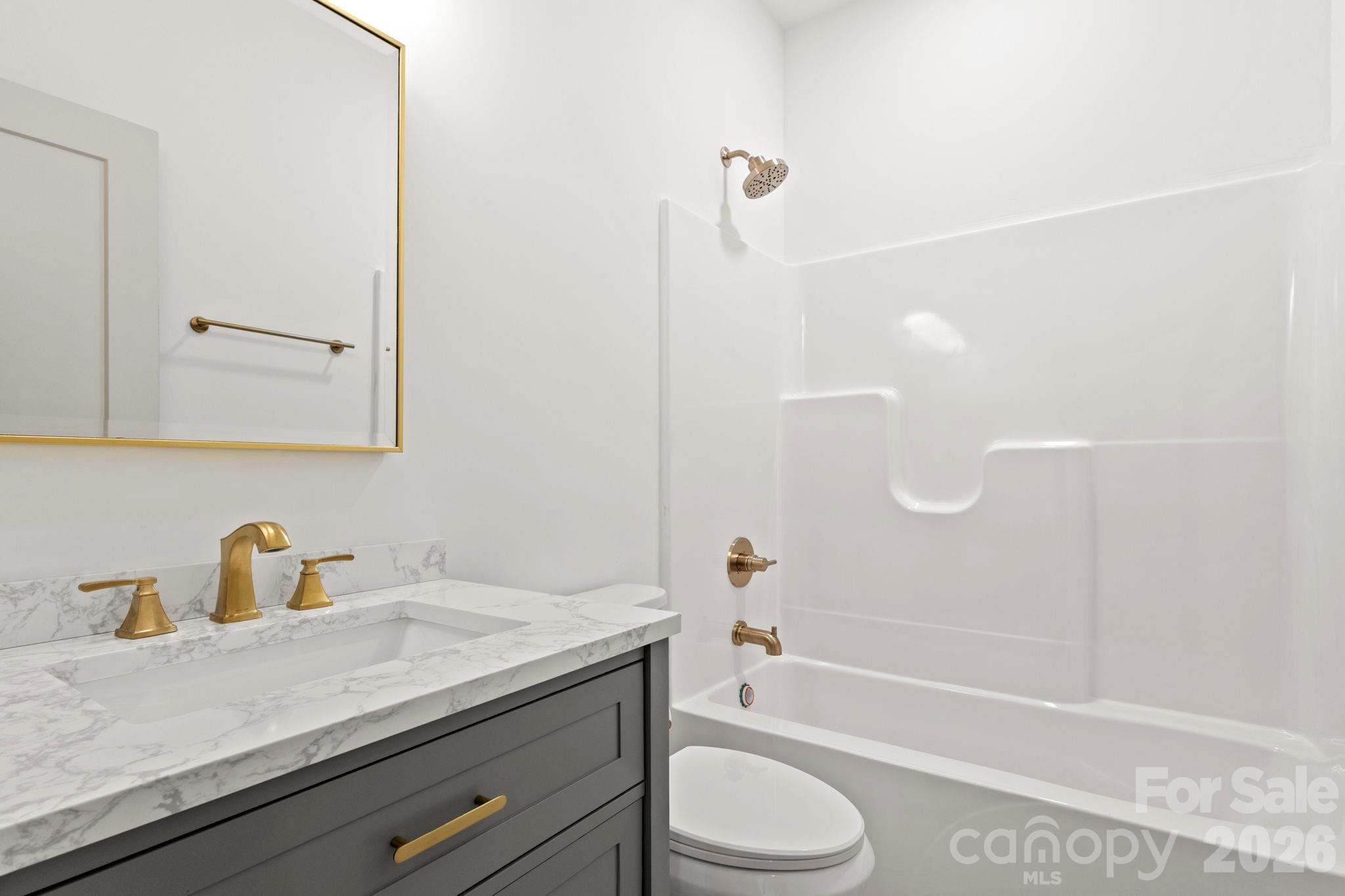 1167 Tirzah Road Rock Hill, SC 29732 - Photo 18 of 25 a bathroom with a granite countertop sink a toilet and bathtub