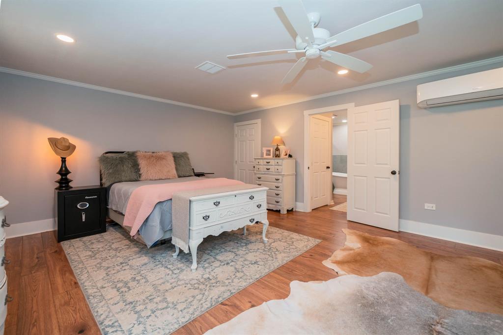 1901 Byrd Road Jacksonville, TX 75766 - Photo 18 of 40 a bed room with a bed and a ceiling fan
