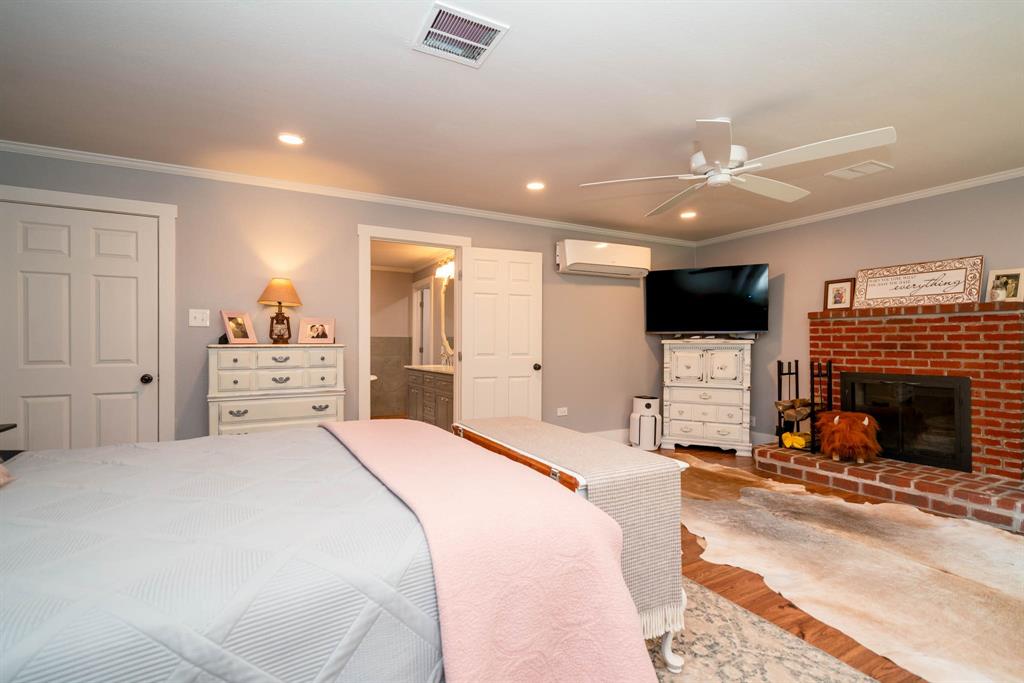 1901 Byrd Road Jacksonville, TX 75766 - Photo 19 of 40 a spacious bedroom with a bed and a fireplace