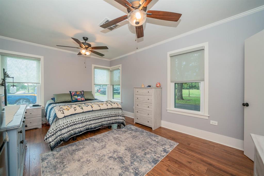 1901 Byrd Road Jacksonville, TX 75766 - Photo 25 of 40 a bedroom with a bed chandelier and a window