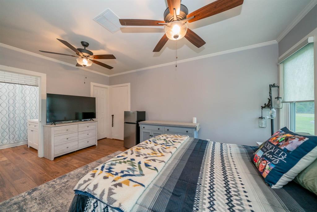 1901 Byrd Road Jacksonville, TX 75766 - Photo 26 of 40 a bedroom with furniture and a flat screen tv