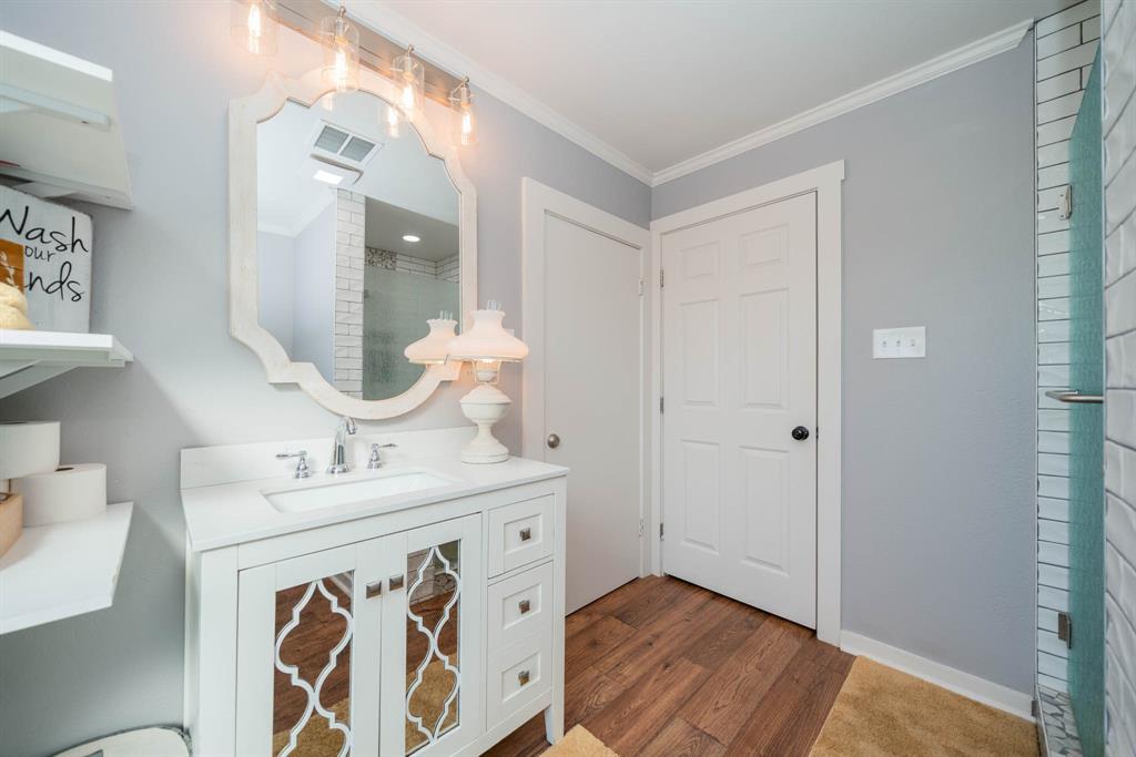 1901 Byrd Road Jacksonville, TX 75766 - Photo 31 of 40 a bathroom with a sink vanity and a mirror