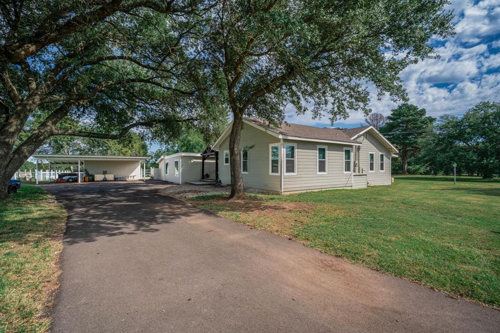 1901 Byrd Road Jacksonville, TX 75766 - Photo 5 of 40 View of side of property with driveway, a yard, and a carport