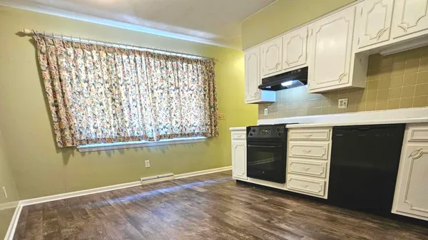 a kitchen with granite countertop a stove and a sink