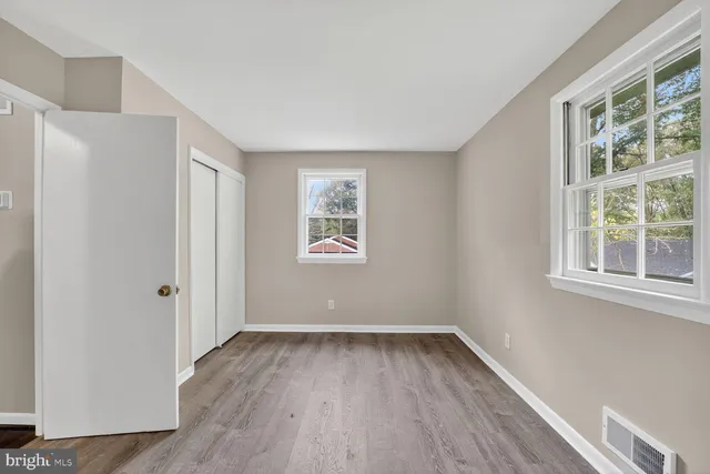 a view of room with hardwood floor and window