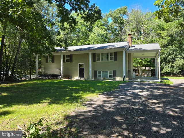 a view of a house with yard and a garden