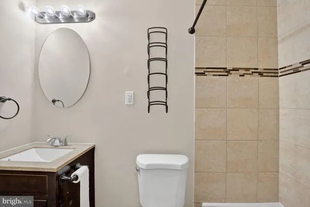 a bathroom with a sink mirror and toilet