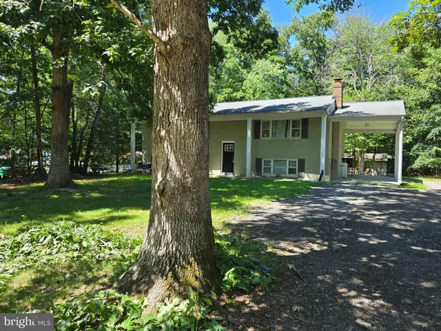 a view of a house with a tree in a yard