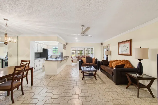a living room with furniture and a dining table with projector the view