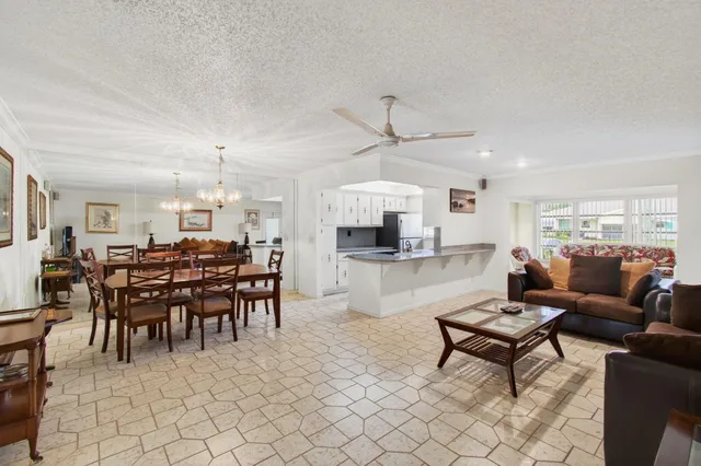 a living room with lots of furniture and kitchen view