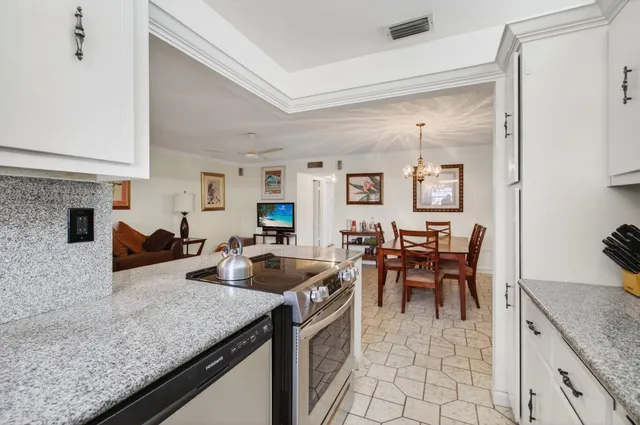 a kitchen with stainless steel appliances granite countertop a sink and a refrigerator