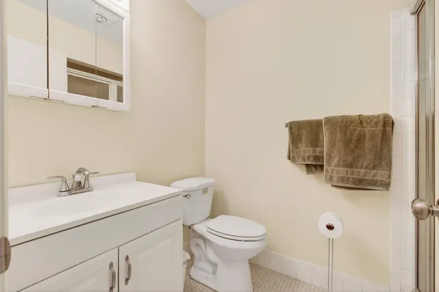 a bathroom with a toilet sink and mirror
