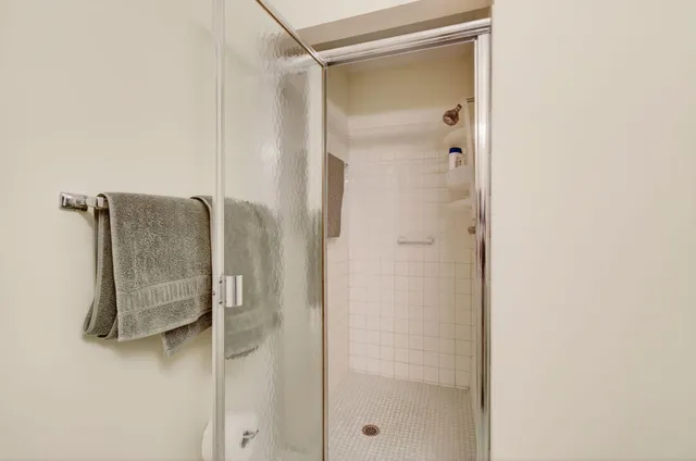 a bathroom with a shower and a mirror