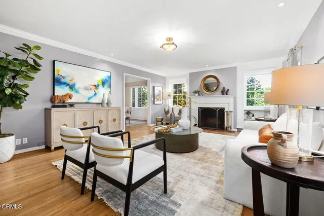 a living room with furniture a fireplace and a table