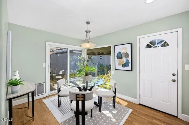 a view of a dining room with furniture window and wooden floor