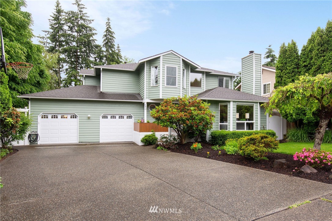 102 237th Place Southwest Bothell, WA 98021 - Photo 1 of 34 a front view of a house with a yard and garage