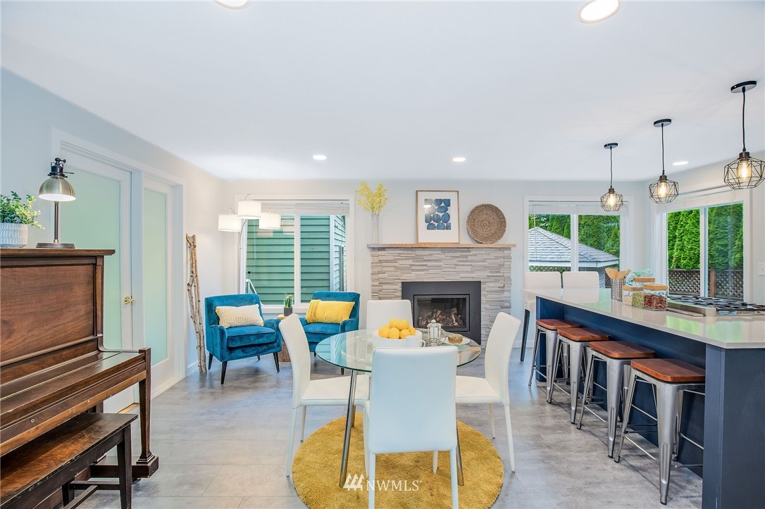 102 237th Place Southwest Bothell, WA 98021 - Photo 10 of 34 a dining room with furniture a fireplace and wooden floor
