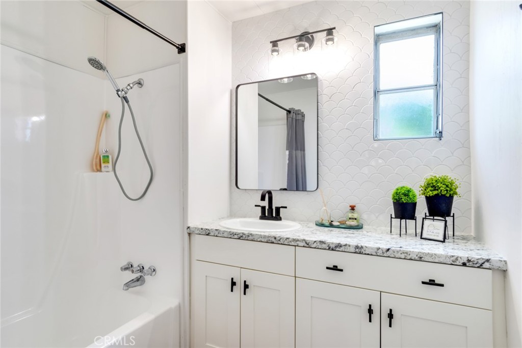 975 California Street, Unit 72 Calimesa, CA 92320 - Photo 20 of 23 a bathroom with a granite countertop sink and a mirror