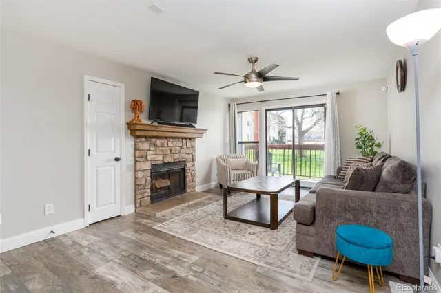 a living room with furniture a fireplace and a flat screen tv
