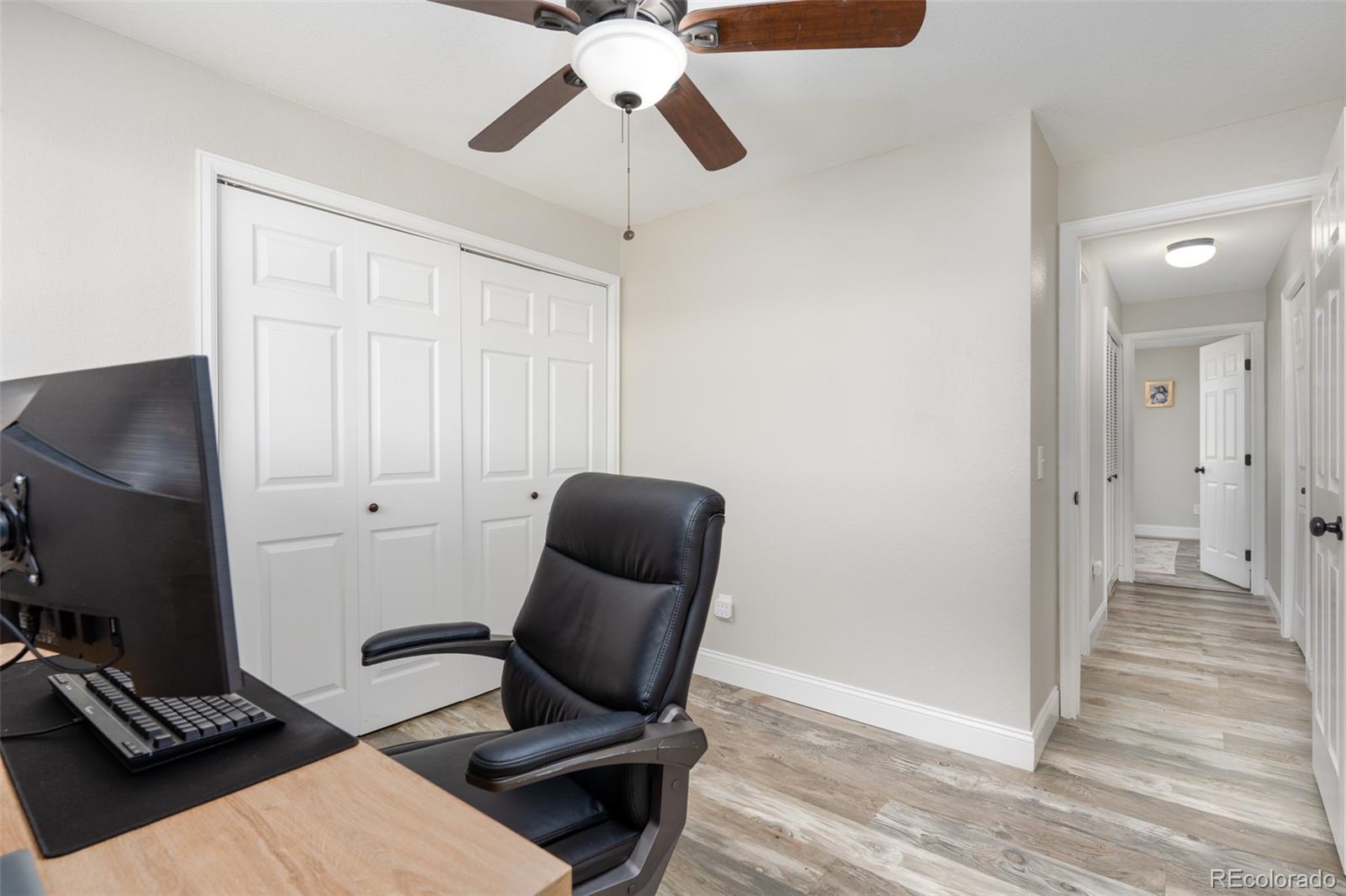 8666 Decatur Street, Unit 254 Westminster, CO 80031 - Photo 10 of 18 a view of workspace with wooden floor windows
