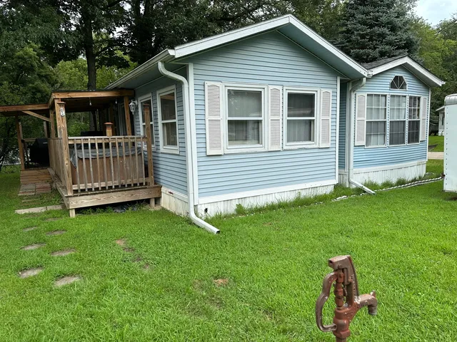 a view of a house with a backyard and deck