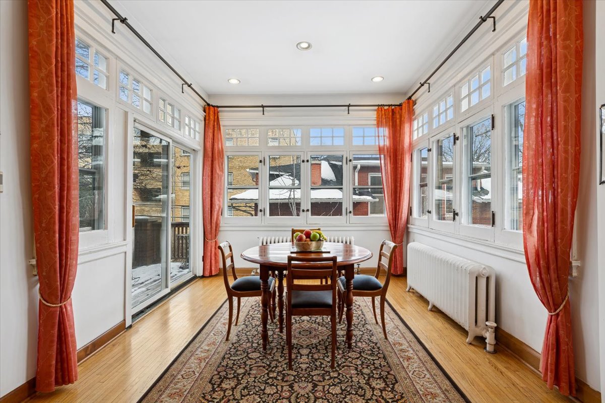 1235 Ridge Avenue Evanston, IL 60202 - Photo 12 of 36 a dining room with furniture large windows and wooden floor
