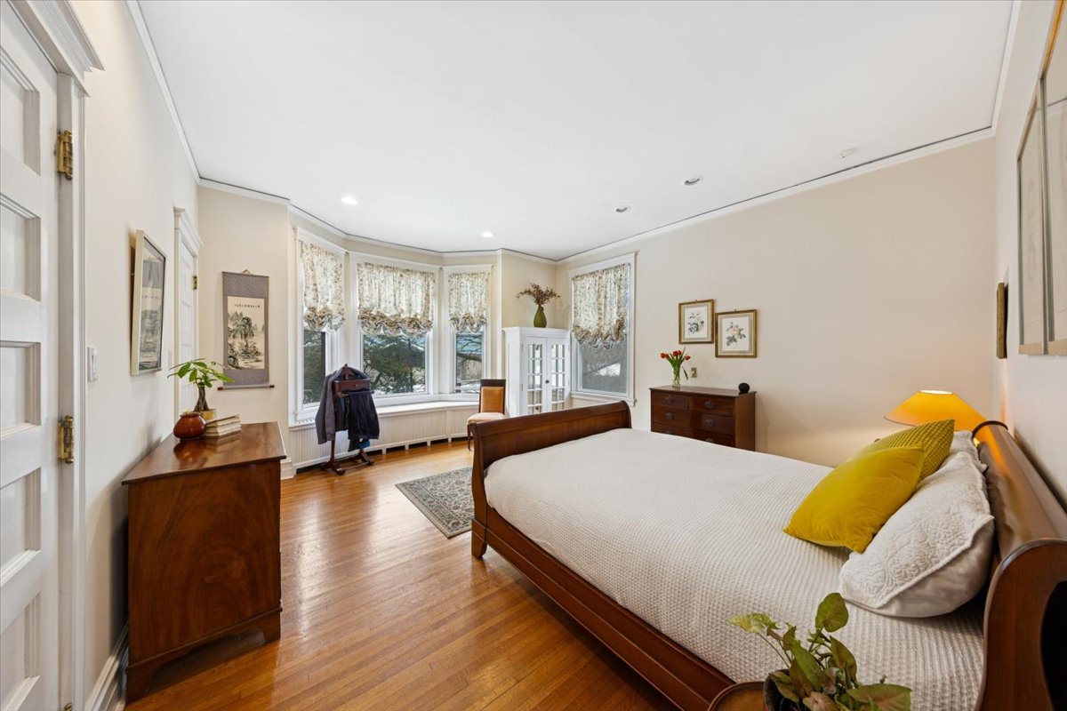 1235 Ridge Avenue Evanston, IL 60202 - Photo 16 of 36 a spacious bedroom with a bed and wooden floor