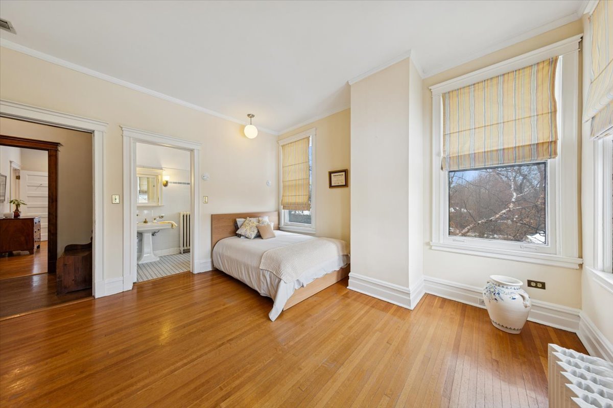 1235 Ridge Avenue Evanston, IL 60202 - Photo 19 of 36 a bedroom with a bed and a painting on the wall