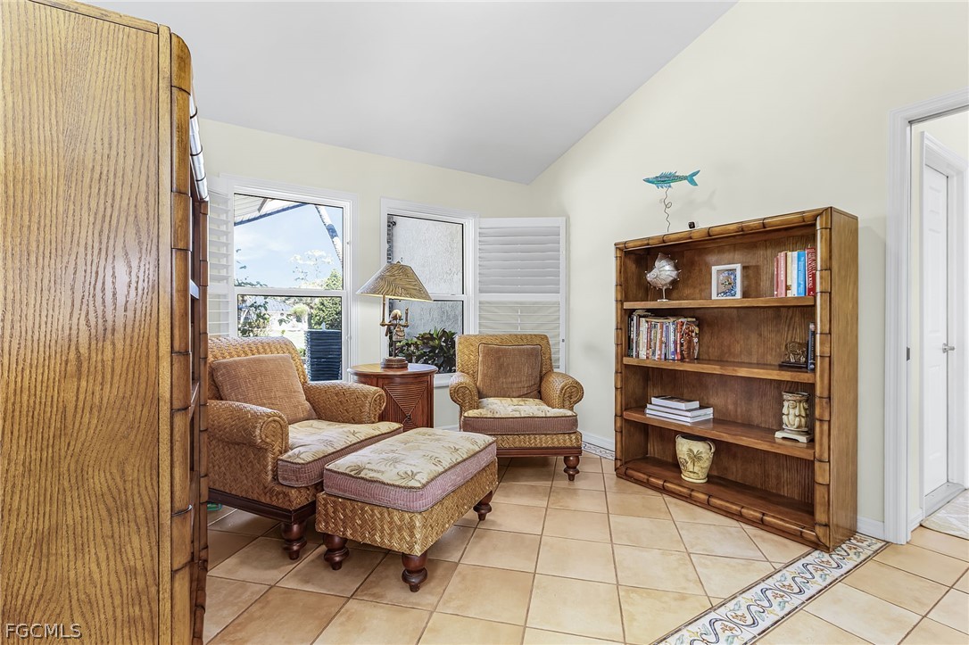 7747 Grande Pine Road Bokeelia, FL 33922 - Photo 9 of 45 a living room with furniture a rug and a window