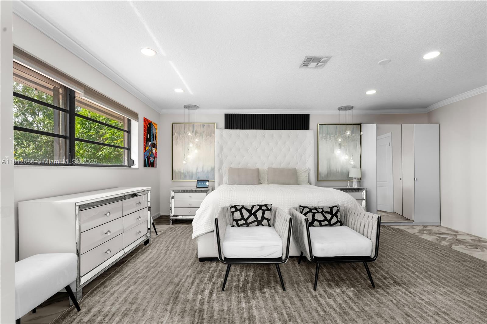 3030 Southwest 117th Avenue Davie, FL 33330 - Photo 16 of 47 a bedroom with a large bed and a wooden floor