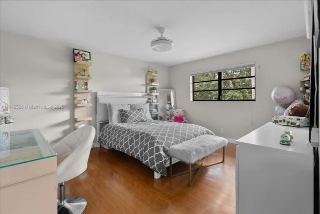 a view of a dining room with furniture a chandelier and window