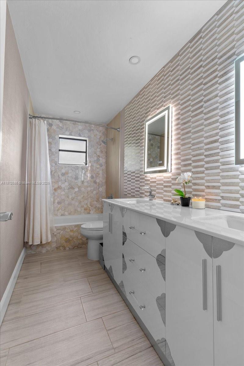 3030 Southwest 117th Avenue Davie, FL 33330 - Photo 23 of 47 a bathroom with a sink a toilet and shower