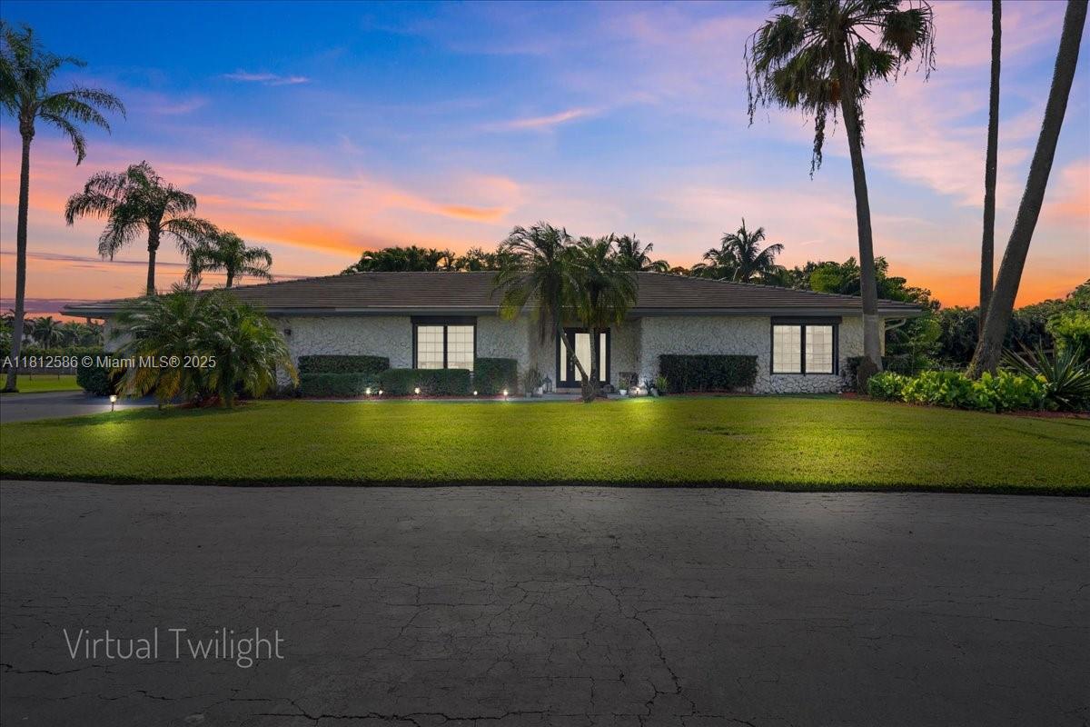 3030 Southwest 117th Avenue Davie, FL 33330 - Photo 3 of 47 a view of house with a big yard and palm trees