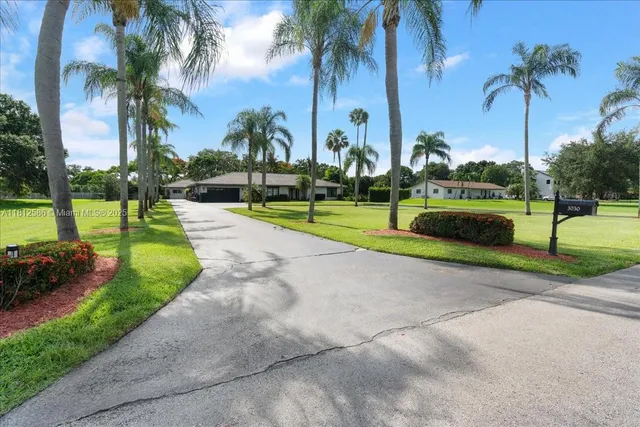 a view of a house with swimming pool and sitting area