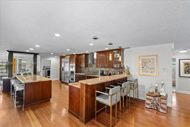 a dining room with furniture a rug and wooden floor