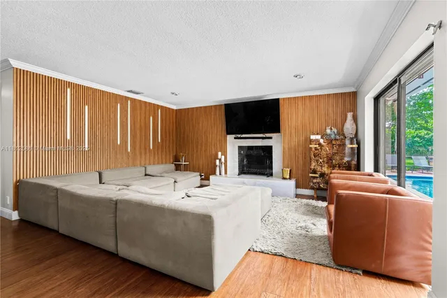 a bedroom with a large bed and a wooden floor