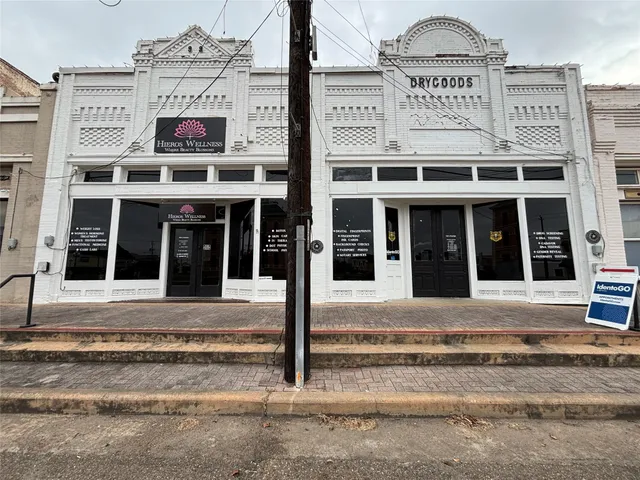 a view of a building with refrigerator and traffic signal