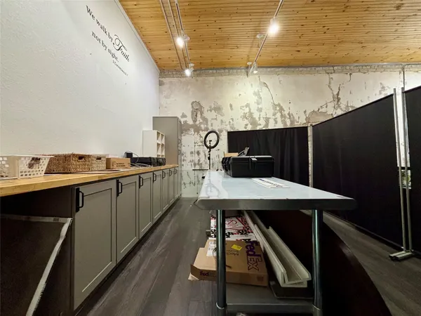 a kitchen with a table chairs and a refrigerator