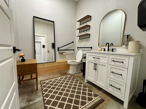 a spacious bathroom with a double vanity sink mirror and toilet