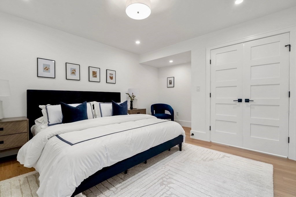 71 Cloverdale Road, Unit 1 Newton, MA 02461 - Photo 11 of 32 a bedroom with a bed and a painting on the wall