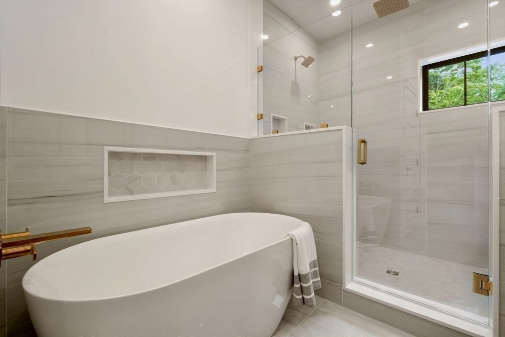 71 Cloverdale Road, Unit 1 Newton, MA 02461 - Photo 13 of 32 a bathroom with a bathtub and a shower